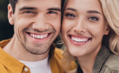 Cropped view portrait of attractive tender amorous affectionate couple bonding resting romance outdoors